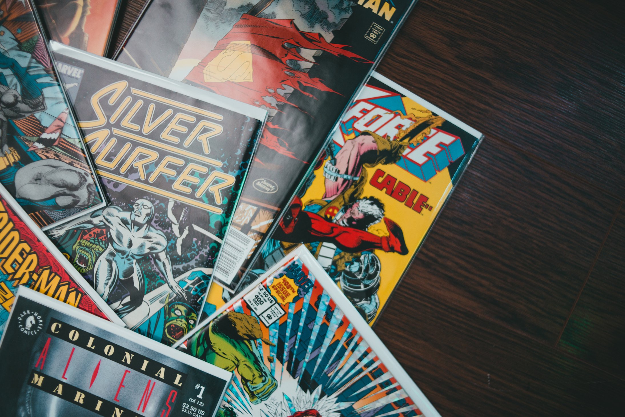 Assorted comic books with colorful covers on floor